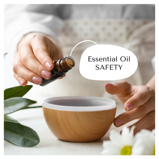 Woman putting essential oil into a decorative wooden diffuser it is surround by white daisies and thick green leaves